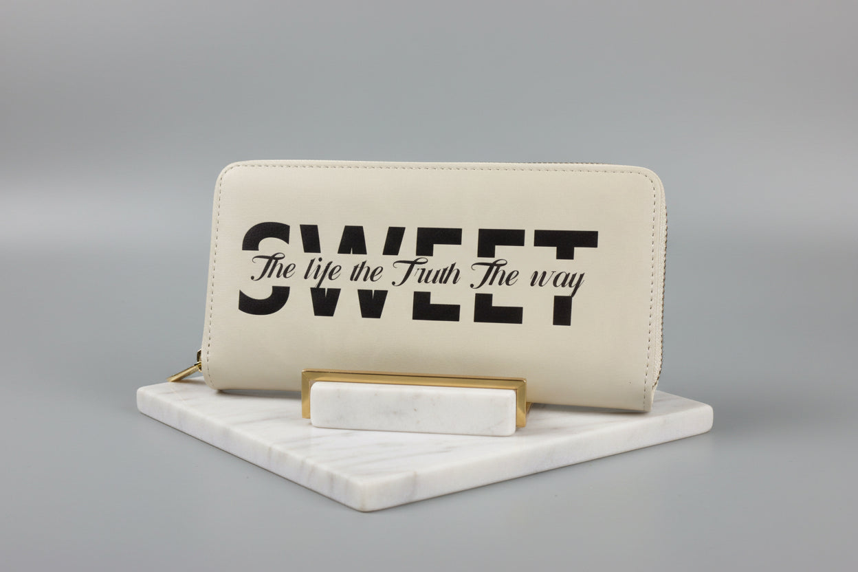 Beige wallet with black text on a gray background